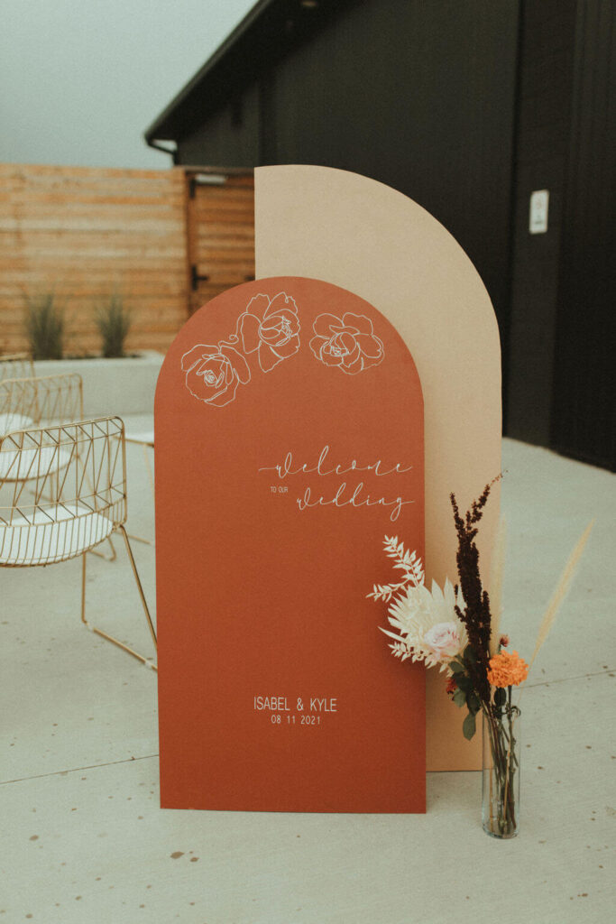 Orange and white welcome signs for boho chic elopement