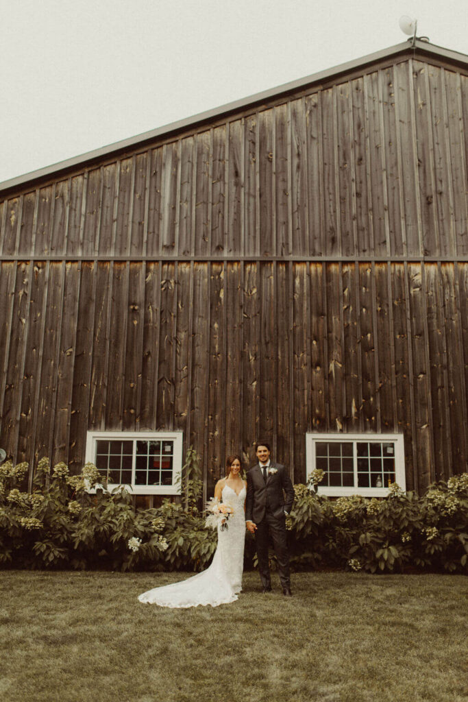 Bride and groom couple portraits in front of a barn