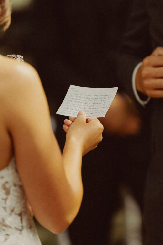 Bride reading vows during wedding ceremony