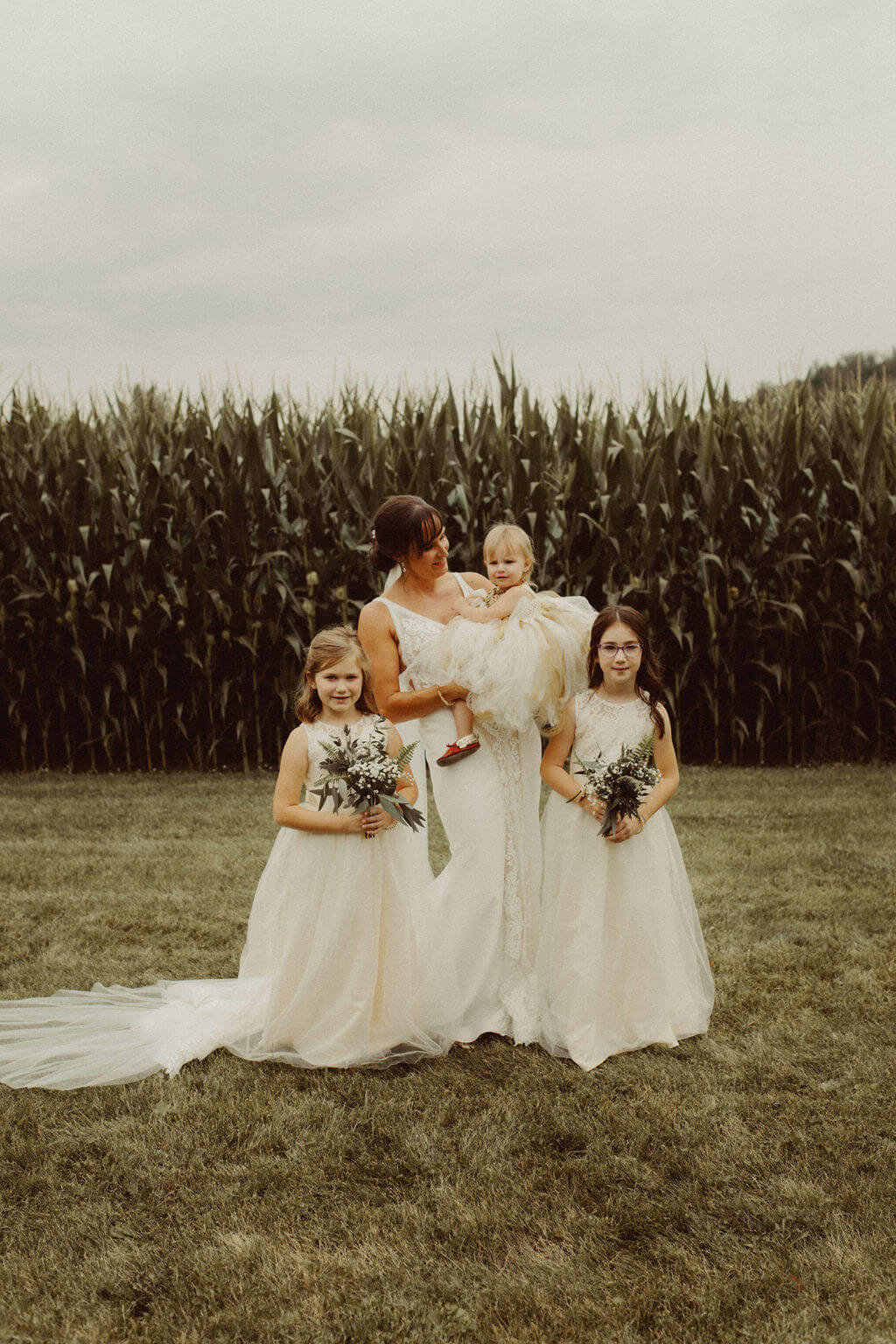 Bride and flower girls at farm wedding