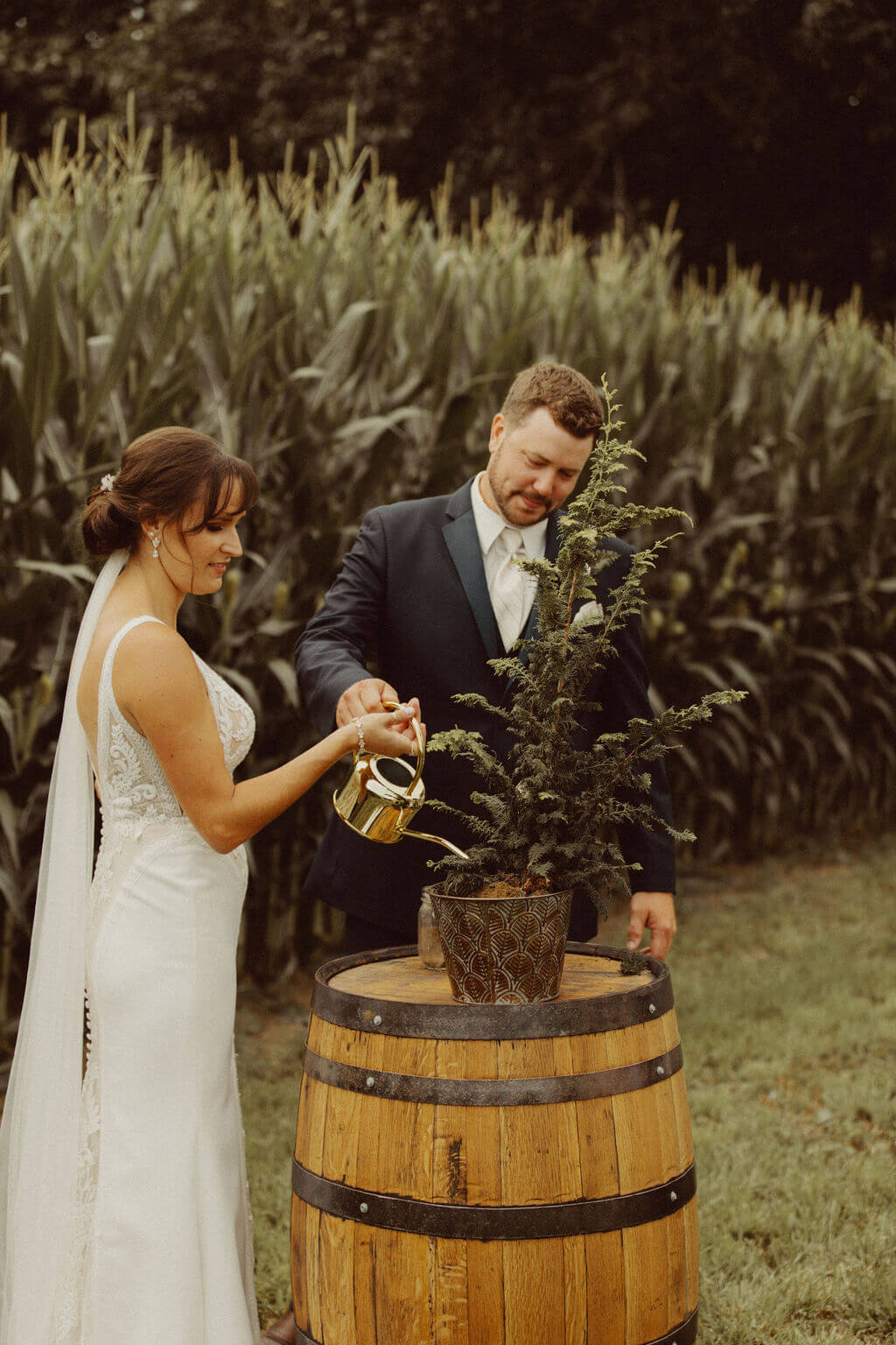 Bride and groom planting tree during private wedding ceremony
