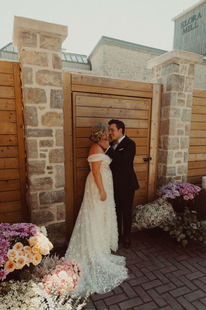 Bride and groom kiss during first look in Elora Ontario 