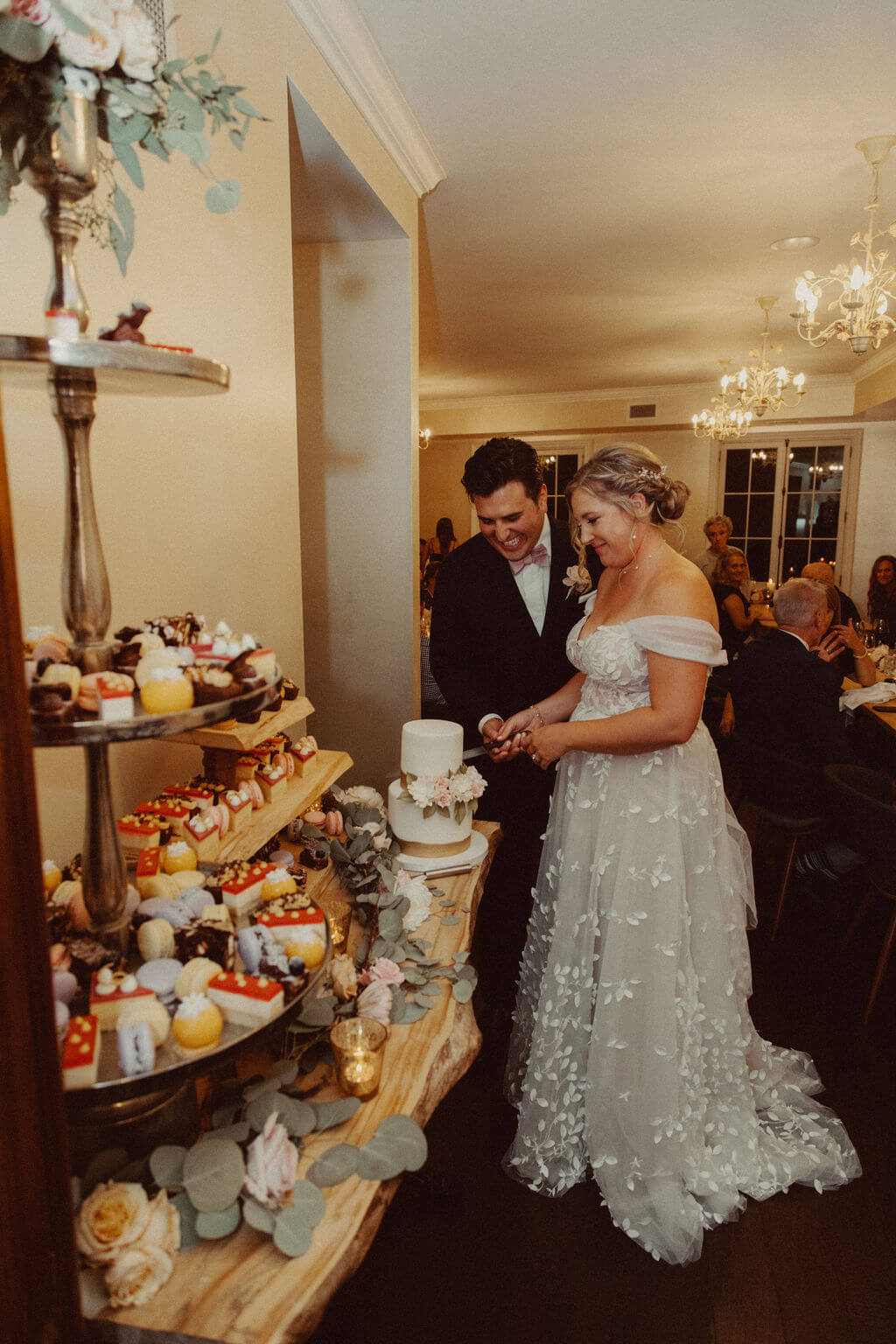 Bride and groom cutting white wedding cake at The Wild Tart