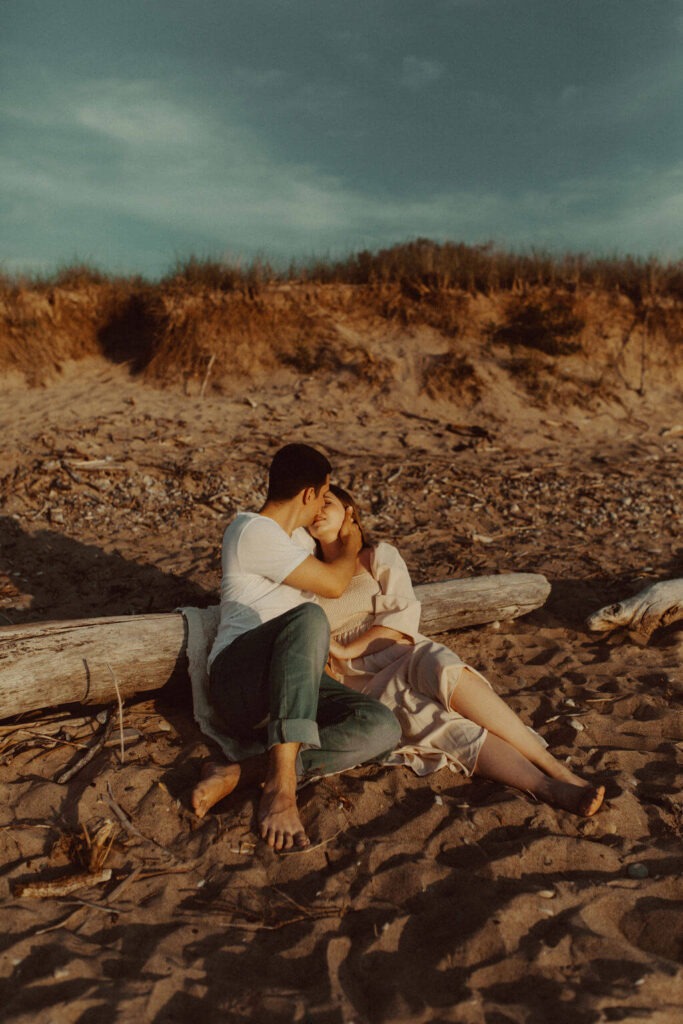Couple kissing on the beach at Grand Bend engagement session