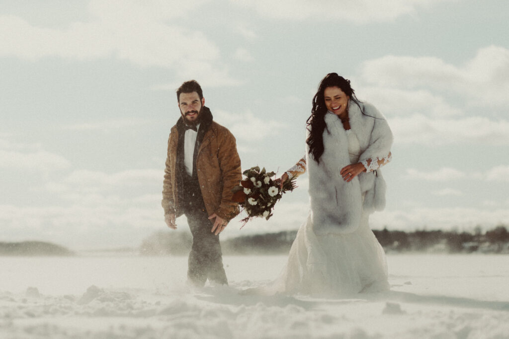 A couple walking in the snow after they figured out how to plan a destination wedding.